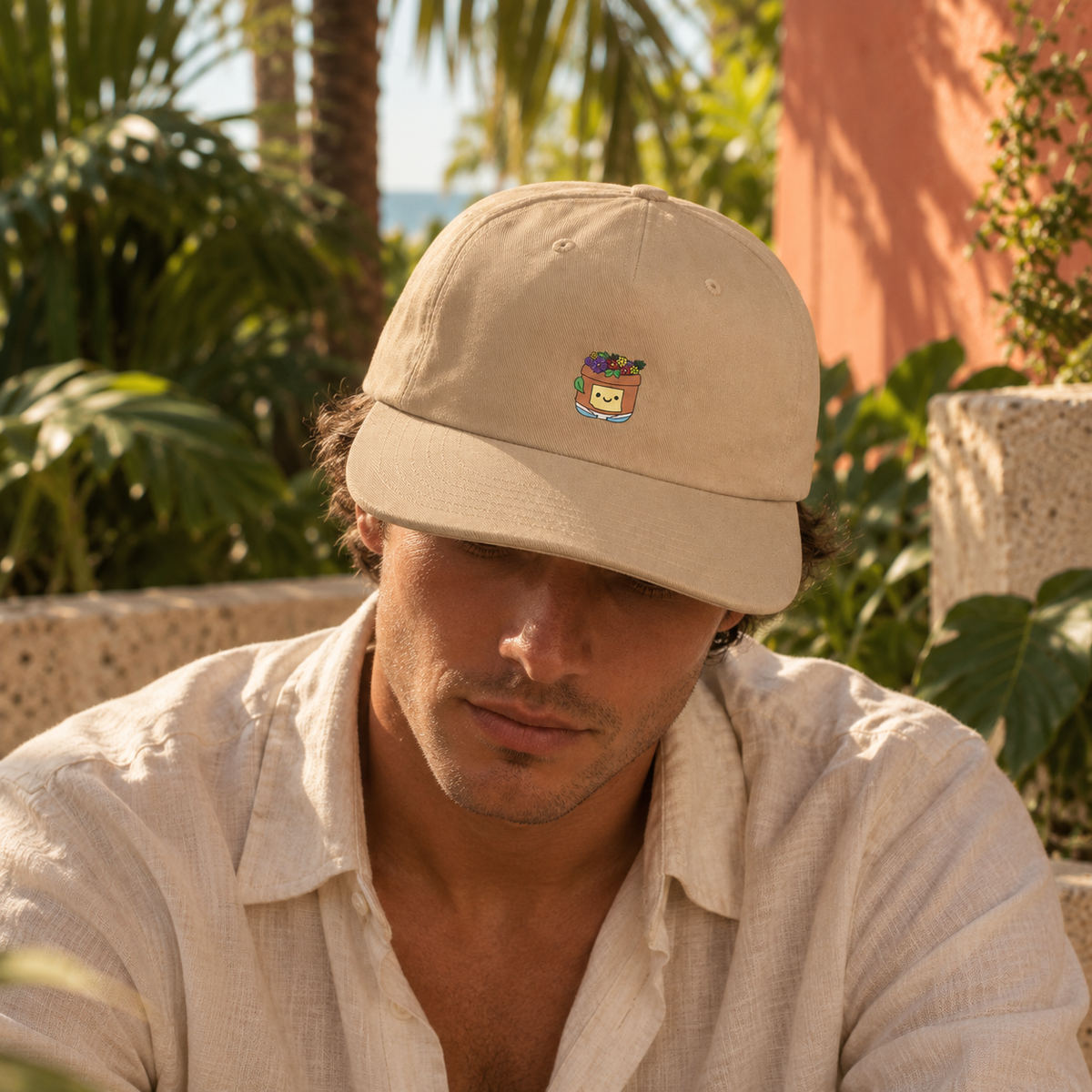 Model wearing the Khaki Pothead Cap with its colorful flowerpot character.