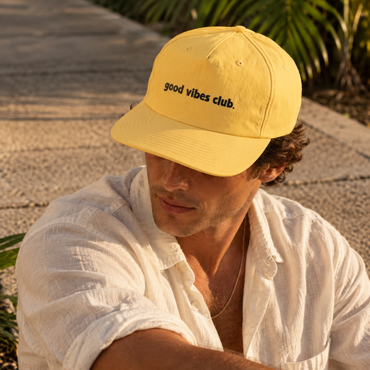 Model wearing the yellow Sunrise Surf Cap outdoors.