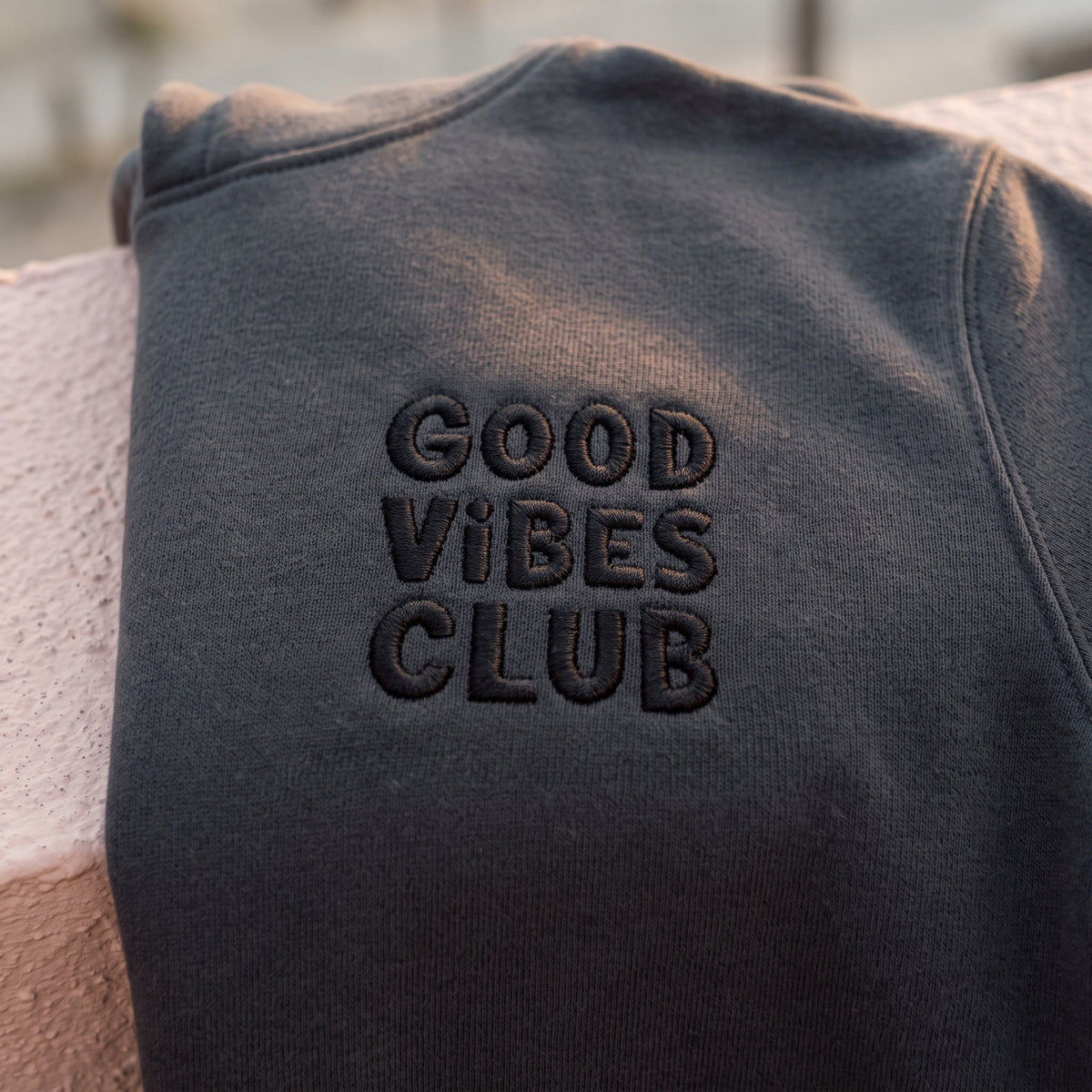 Close-up of the black Good Vibes Club embroidery on the Faded Black Club Hoodie.