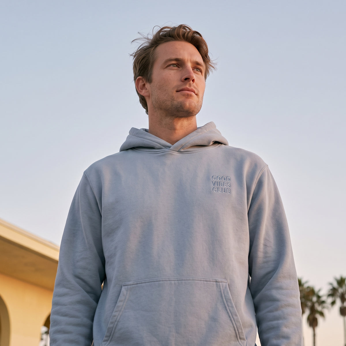 Model wearing the Faded Powder Club Hoodie outdoors.